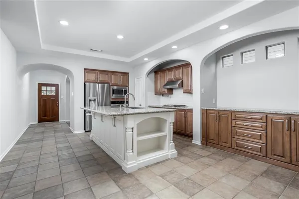 a kitchen with stainless steel appliances a sink and cabinets