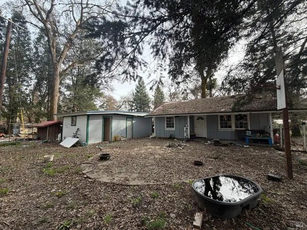 a backyard of a house with barbeque oven fire pit table and chairs