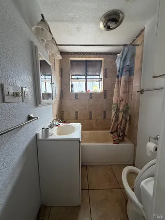 a bath tub sitting in a bathroom next to a window