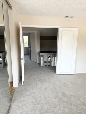 a view of a livingroom with furniture and an empty room