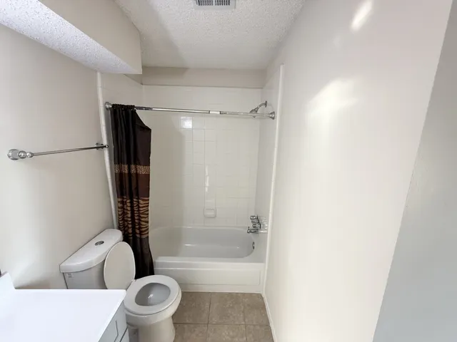 a bathroom with a toilet a sink and bathtub
