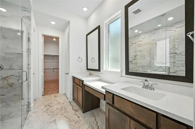 a bathroom with a sink double vanity and a shower