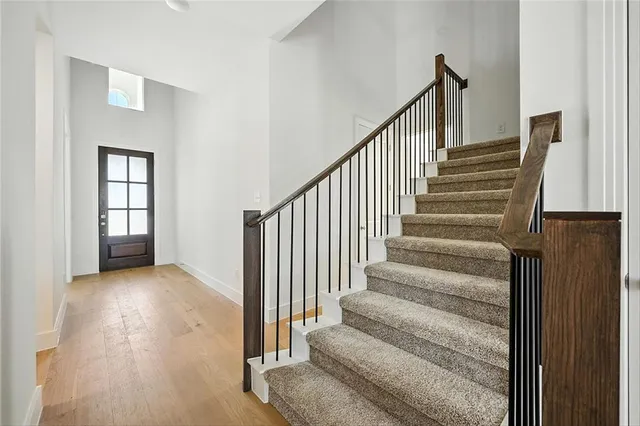 a view of entryway and hall with wooden floor