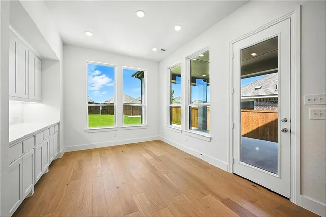 a view of an entryway with wooden floor and windows
