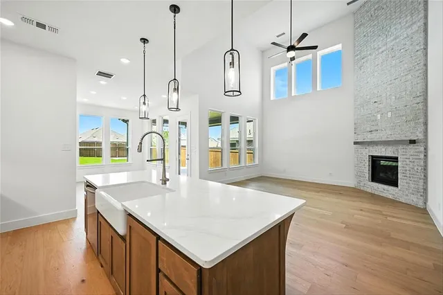a kitchen with sink cabinets and wooden floor