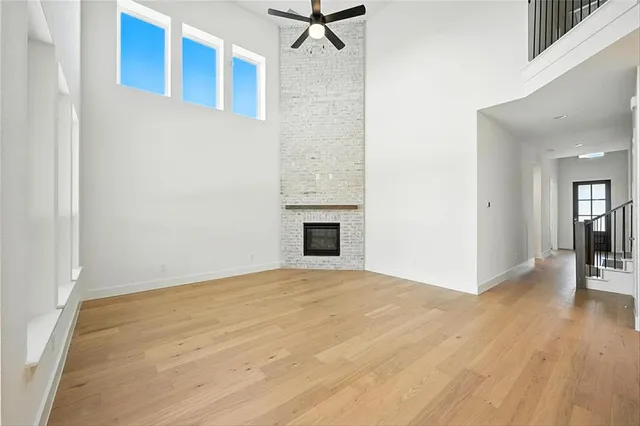 a view of a livingroom with wooden floor and a ceiling fan