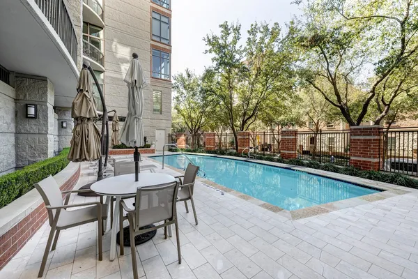 a view of a patio with a table and chairs next to a yard