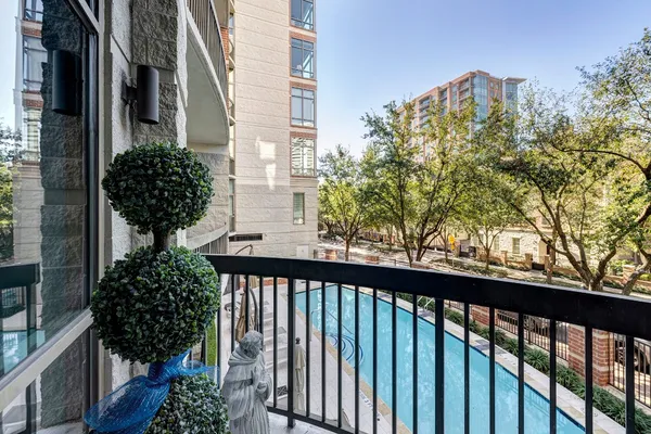 a view of a balcony with flower plants