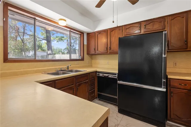 a kitchen with stainless steel appliances granite countertop a refrigerator and a sink