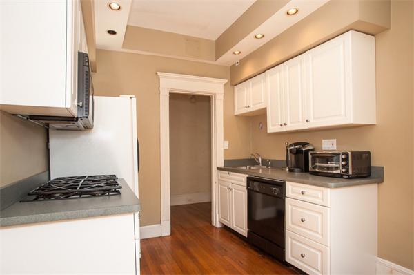 8 Garrison Street, Unit 209 Boston, MA 02116 - Photo 2 of 13 a kitchen with stainless steel appliances granite countertop white cabinets and a stove