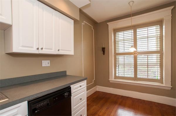 8 Garrison Street, Unit 209 Boston, MA 02116 - Photo 3 of 13 a kitchen with granite countertop a stove and a white cabinets