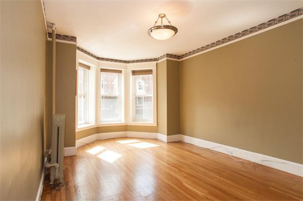8 Garrison Street, Unit 209 Boston, MA 02116 - Photo 4 of 13 a view of a livingroom with wooden floor and windows