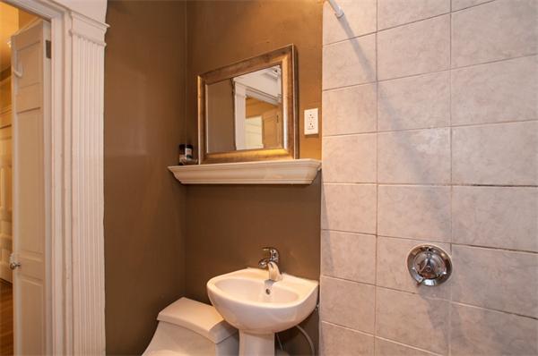 8 Garrison Street, Unit 209 Boston, MA 02116 - Photo 7 of 13 a bathroom with a sink and a mirror