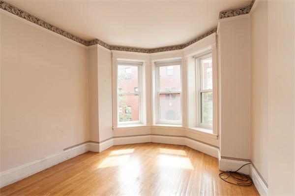 8 Garrison Street, Unit 209 Boston, MA 02116 - Photo 8 of 13 an empty room with wooden floor and windows