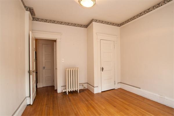 8 Garrison Street, Unit 209 Boston, MA 02116 - Photo 9 of 13 a view of empty room with wooden floor and window