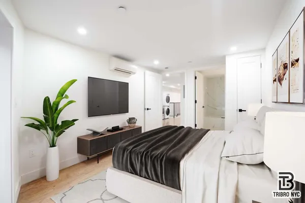 a bedroom with a bed and a potted plant