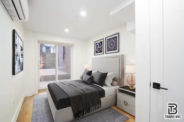 a bedroom with a bed and a painting on the wall