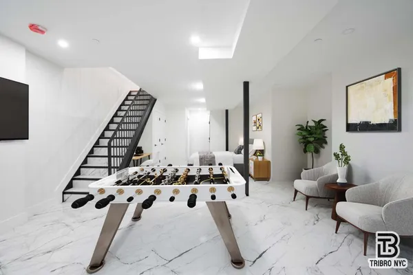 a living room with furniture and a potted plant