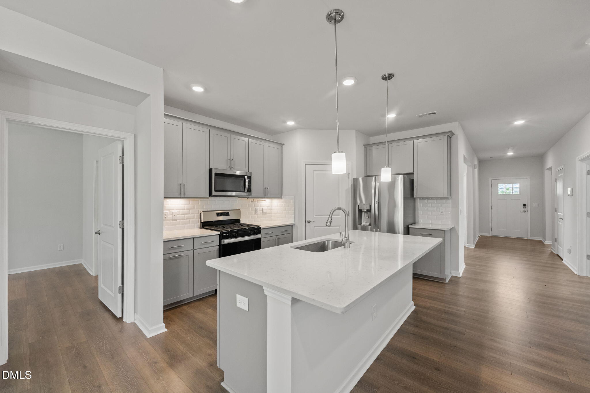 1639 Abberly Place Graham, NC 27253 - Photo 11 of 44 a large white kitchen with a center island and stainless steel appliances