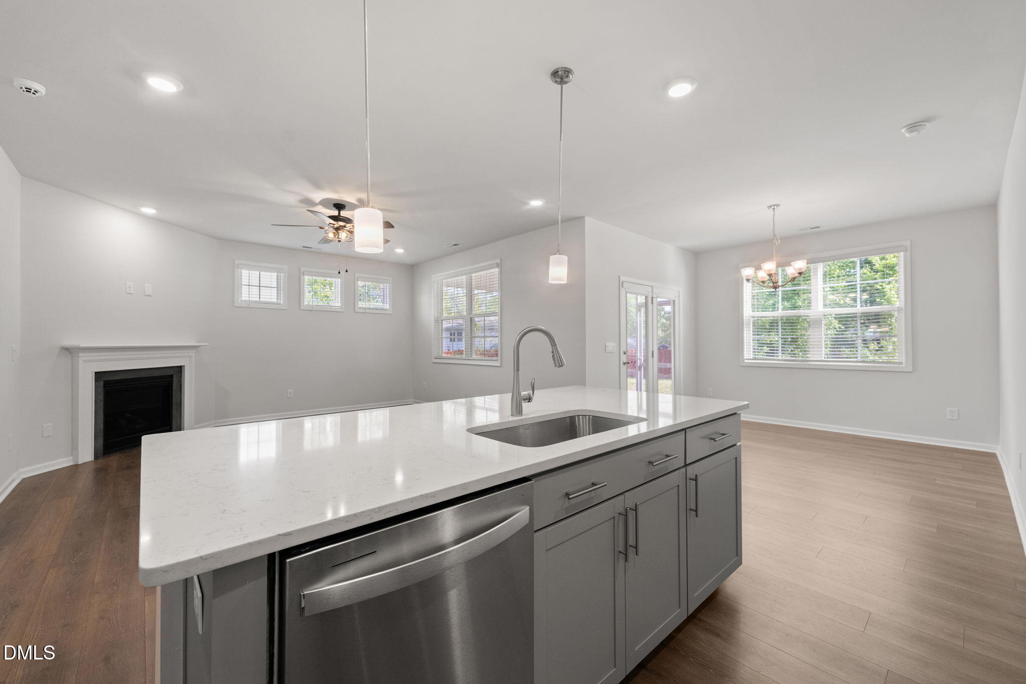 1639 Abberly Place Graham, NC 27253 - Photo 13 of 44 a kitchen with a sink chandelier and wooden floor
