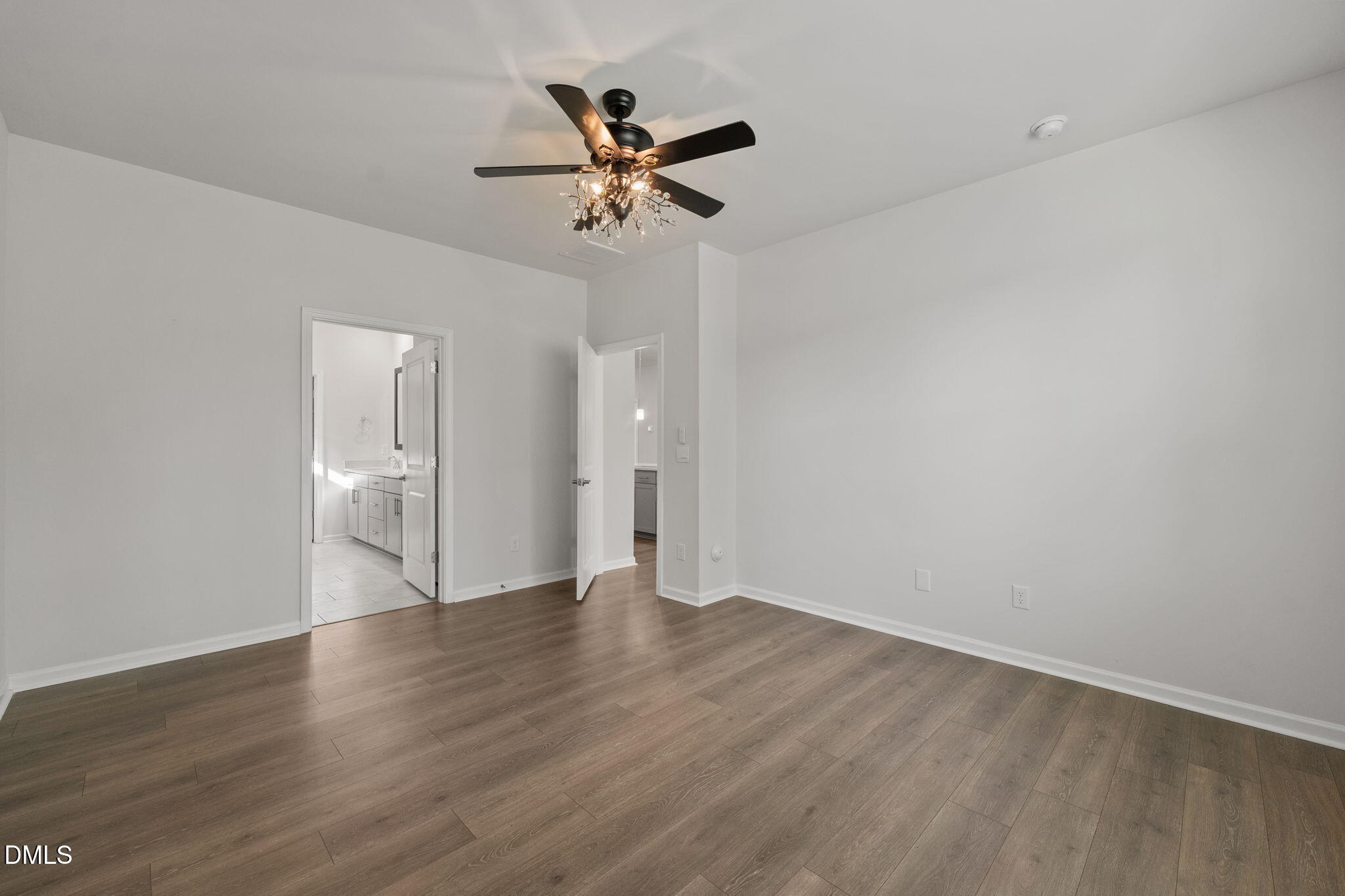1639 Abberly Place Graham, NC 27253 - Photo 17 of 44 a view of an empty room with wooden floor and a ceiling fan