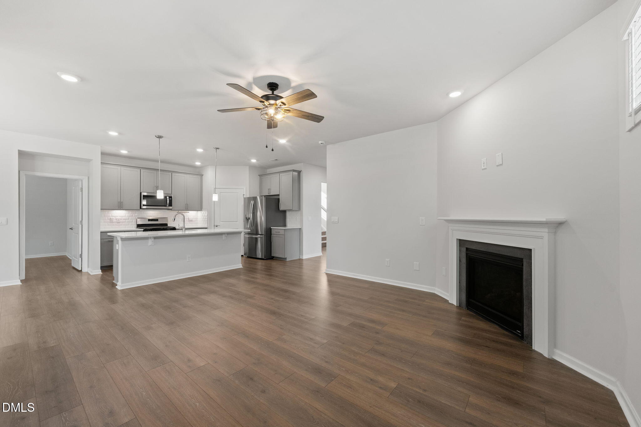 1639 Abberly Place Graham, NC 27253 - Photo 7 of 44 a view of kitchen with kitchen island wooden floor and refrigerator