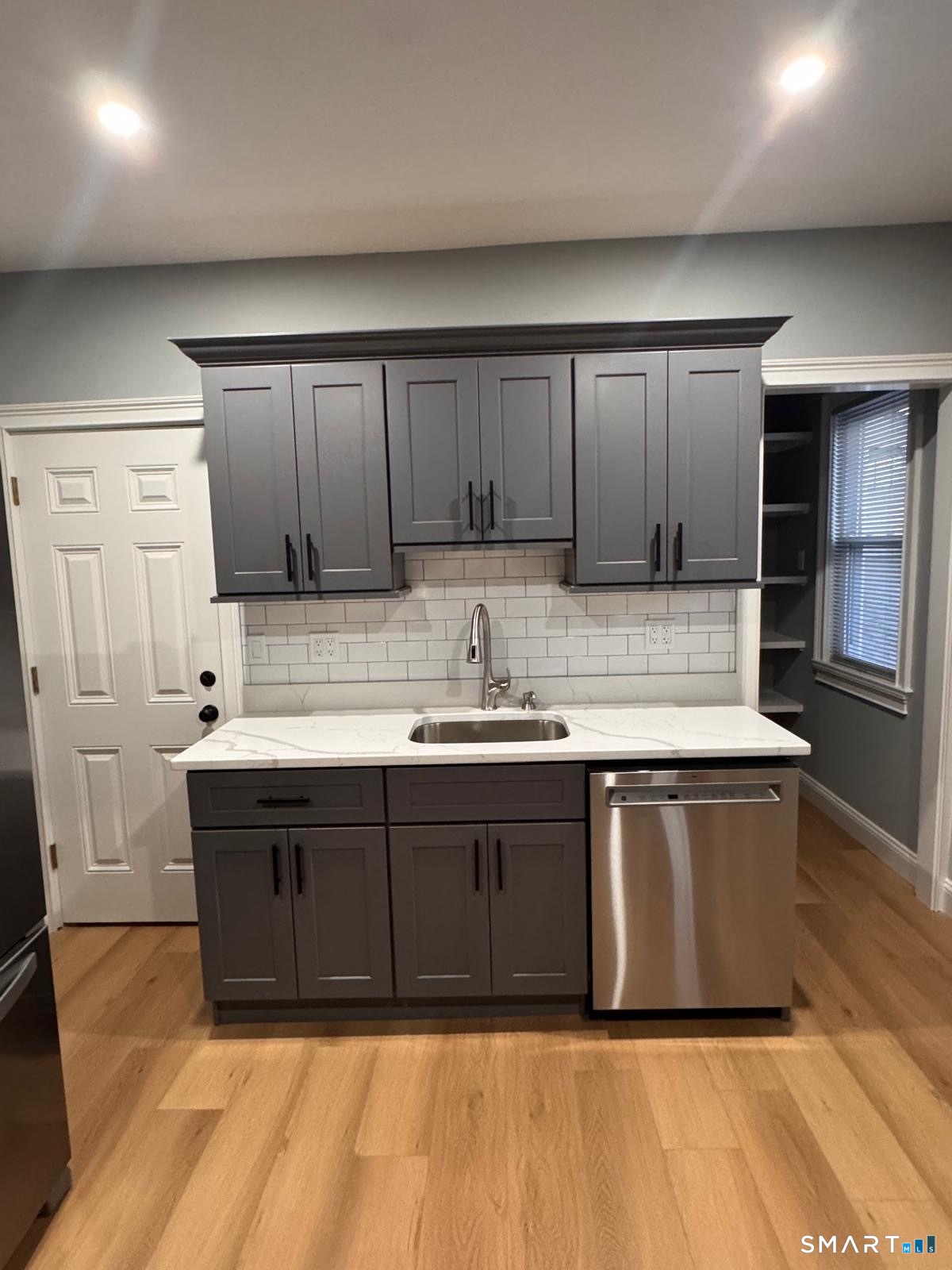 162 Fox Street, Unit 2 Bridgeport, CT 06605 - Photo 3 of 23 a kitchen with stainless steel appliances granite countertop a sink and a stove