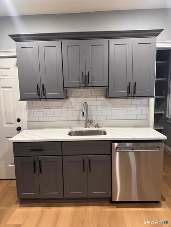 a kitchen with a sink and cabinets