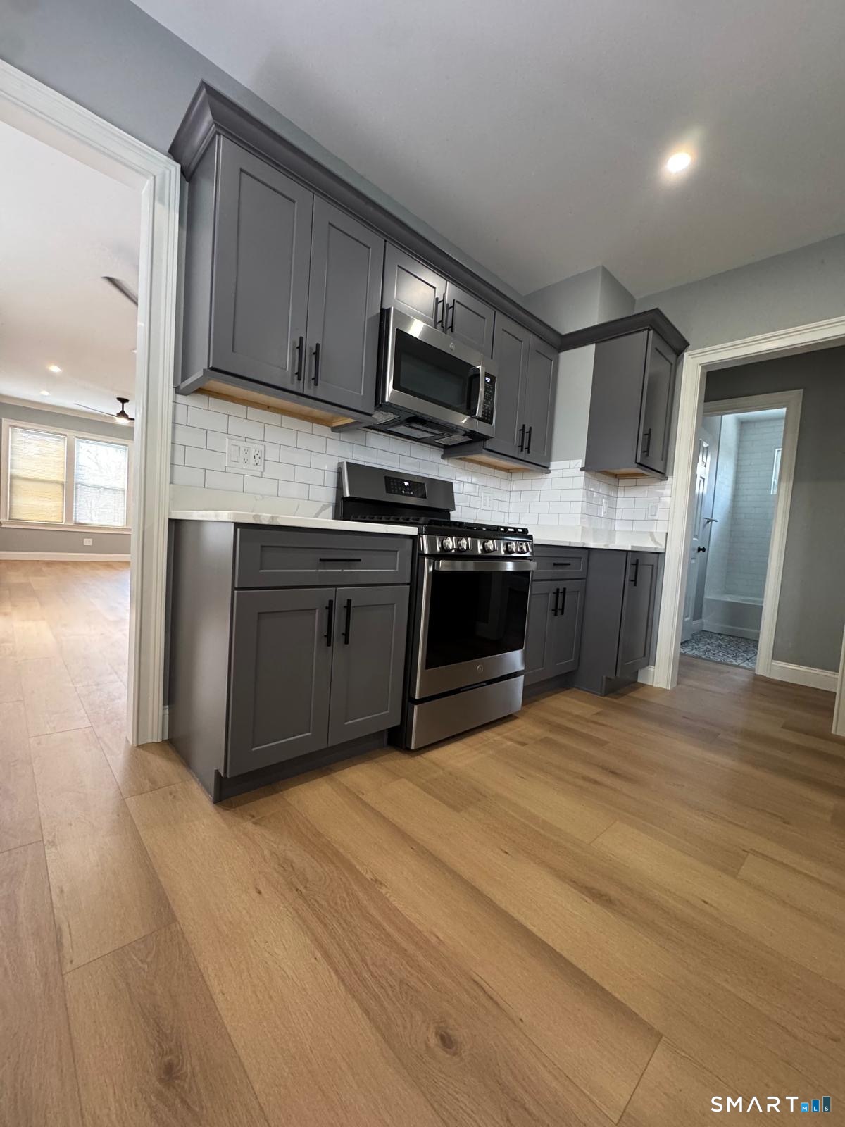 162 Fox Street, Unit 2 Bridgeport, CT 06605 - Photo 5 of 23 a kitchen with stainless steel appliances granite countertop a stove a sink and a microwave