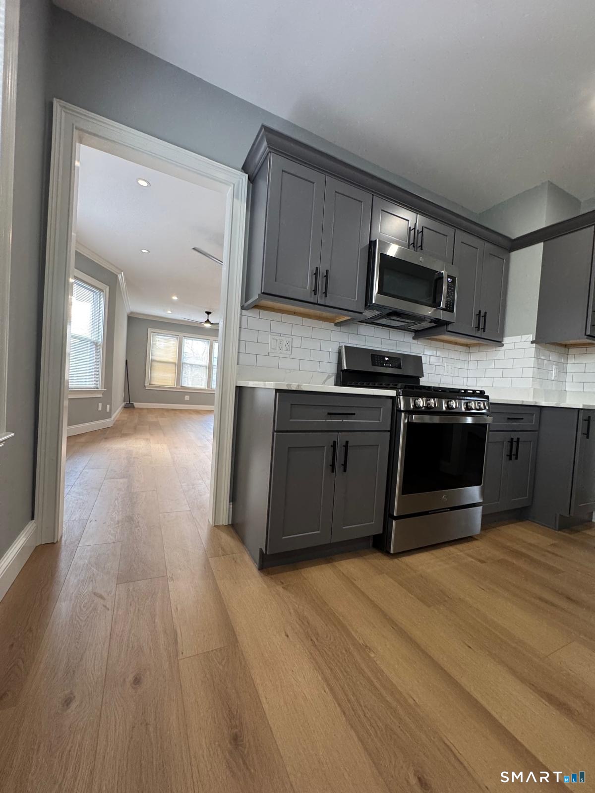 162 Fox Street, Unit 2 Bridgeport, CT 06605 - Photo 6 of 23 a kitchen with stainless steel appliances granite countertop a stove a sink and a microwave