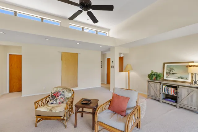 a dining room with furniture and a garden view