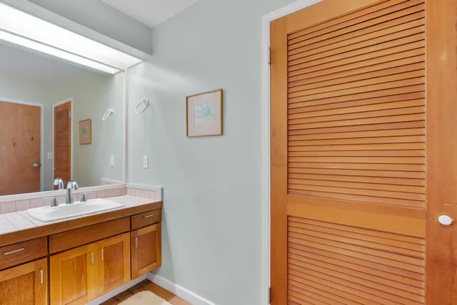 a bedroom with a bed a couch and dresser