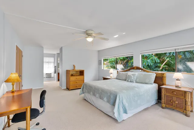 a spacious bathroom with a double vanity sink a mirror and a bathtub