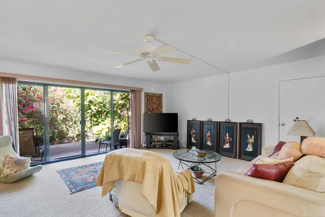 a view of a room with a large window and front door