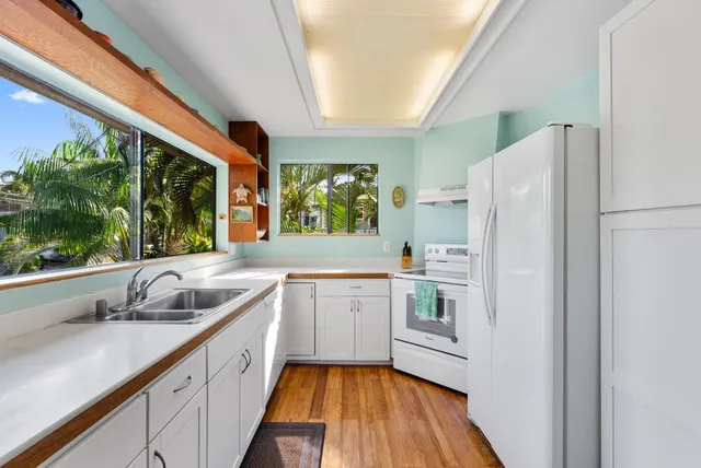 a kitchen with a sink and a large window