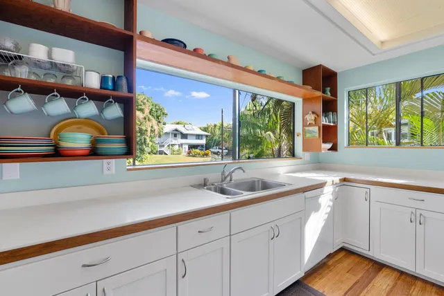 a living room with furniture a chandelier and a large window