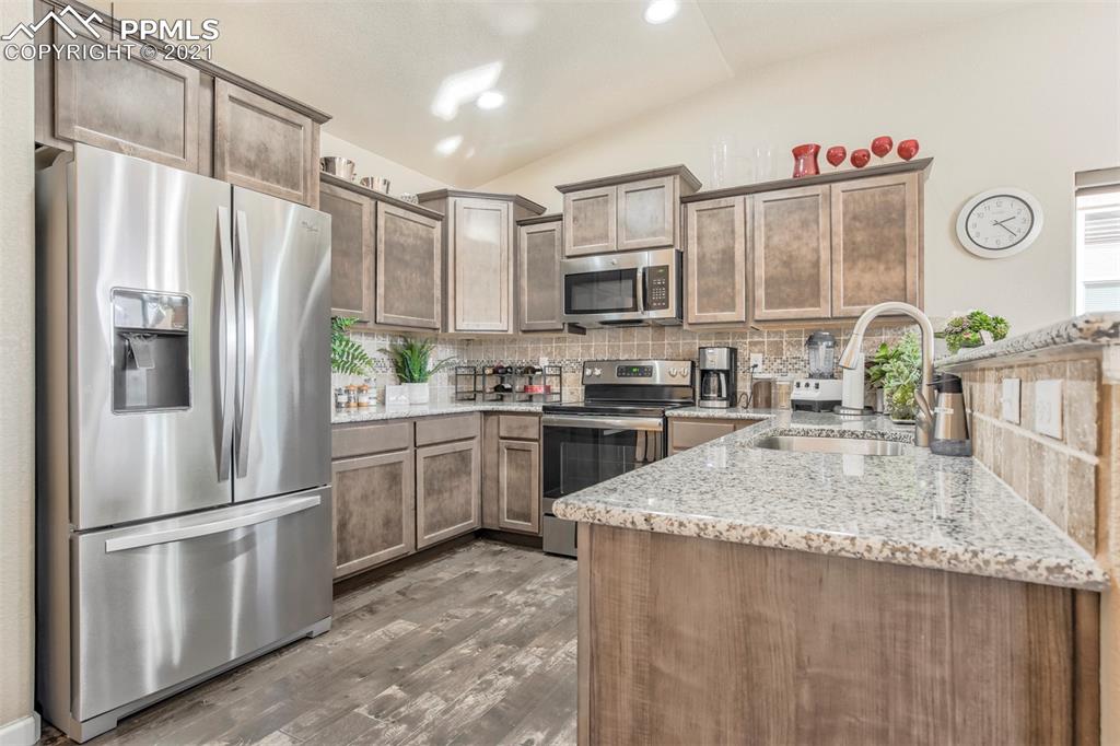 835 Citrine View Colorado Springs, CO 80921 - Photo 12 of 50 a kitchen with stainless steel appliances granite countertop a refrigerator sink and stove