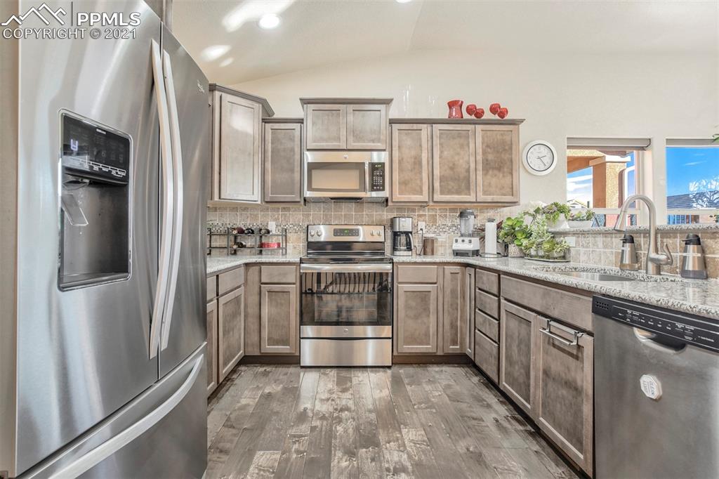 835 Citrine View Colorado Springs, CO 80921 - Photo 13 of 50 a kitchen with stainless steel appliances a refrigerator sink and microwave