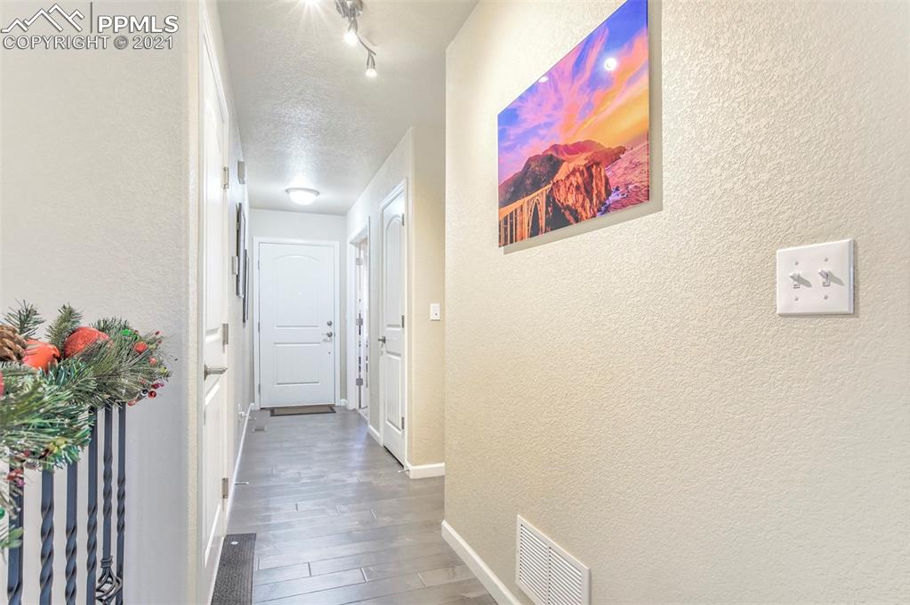 835 Citrine View Colorado Springs, CO 80921 - Photo 15 of 50 a view of a hallway with flower pot and a dining table