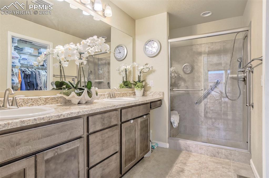 835 Citrine View Colorado Springs, CO 80921 - Photo 18 of 50 a bathroom with a double vanity sink mirror and shower