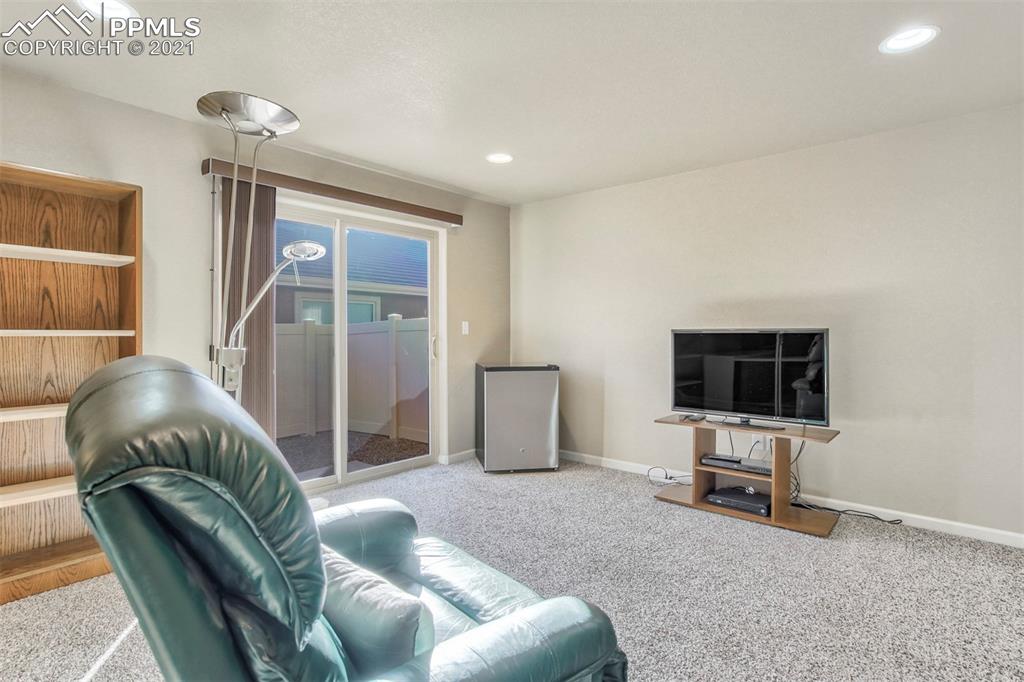 835 Citrine View Colorado Springs, CO 80921 - Photo 27 of 50 a living room with furniture and a flat screen tv
