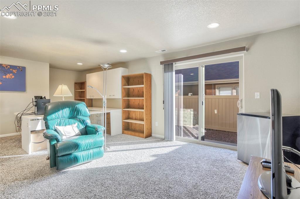 835 Citrine View Colorado Springs, CO 80921 - Photo 28 of 50 a living room with furniture and a large window