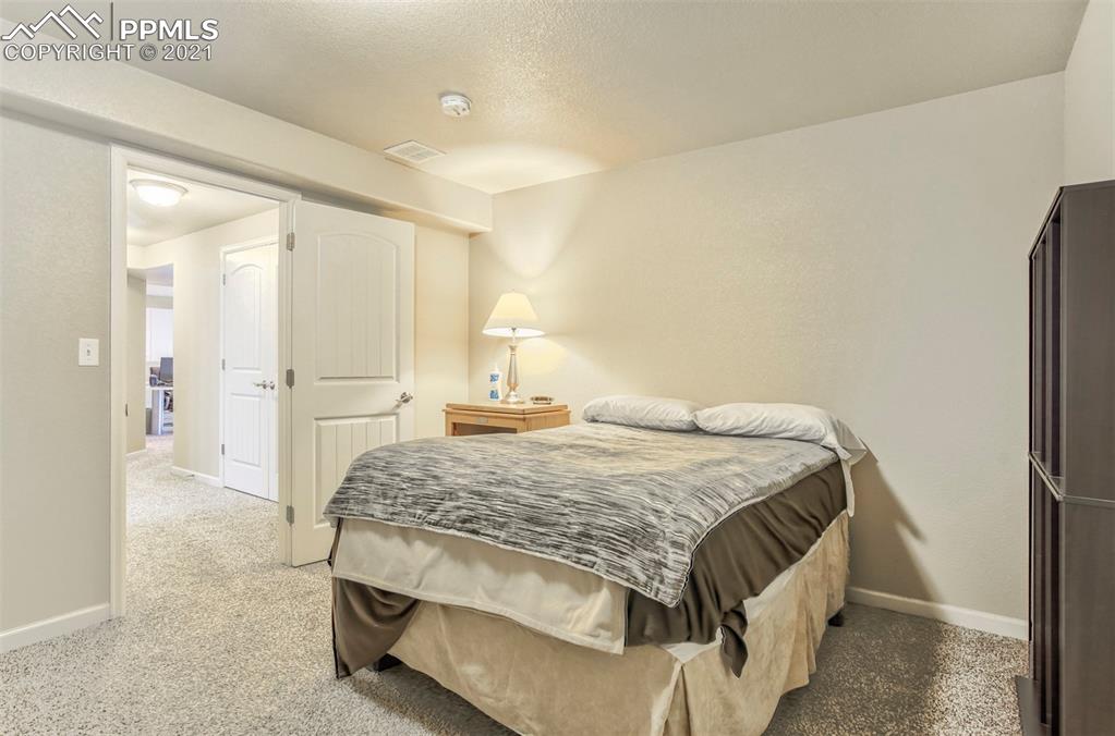 835 Citrine View Colorado Springs, CO 80921 - Photo 35 of 50 a spacious bedroom with a bed and a cabinets