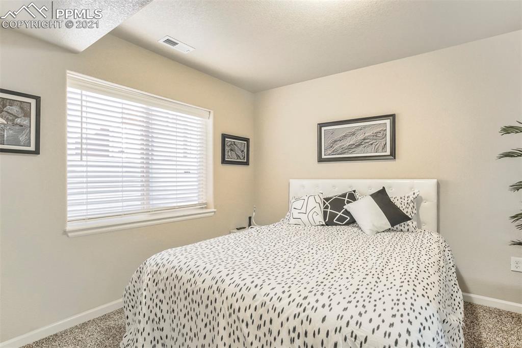 835 Citrine View Colorado Springs, CO 80921 - Photo 38 of 50 a bedroom with a bed and a window