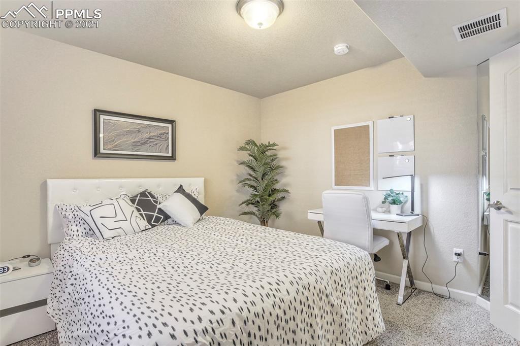 835 Citrine View Colorado Springs, CO 80921 - Photo 39 of 50 a bedroom with a bed and a lamp