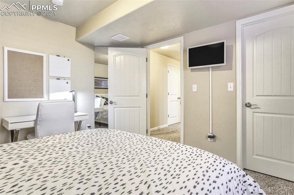835 Citrine View Colorado Springs, CO 80921 - Photo 40 of 50 a bedroom with a bed and a view of bathroom
