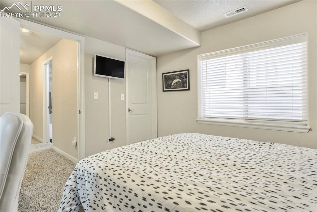835 Citrine View Colorado Springs, CO 80921 - Photo 41 of 50 a bedroom with a bed and a window