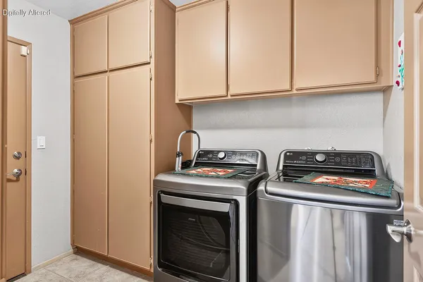 a kitchen with stainless steel appliances granite countertop a stove a washer and dryer