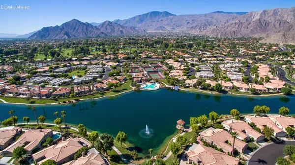 an aerial view of a houses with a lake