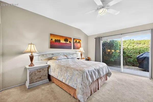 a bedroom with a bed and a large window